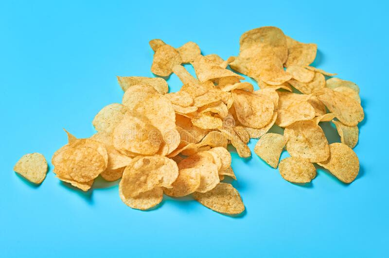 Scattered many fried potato chips blue background scattered many fried potato chips blue background close up 171462150