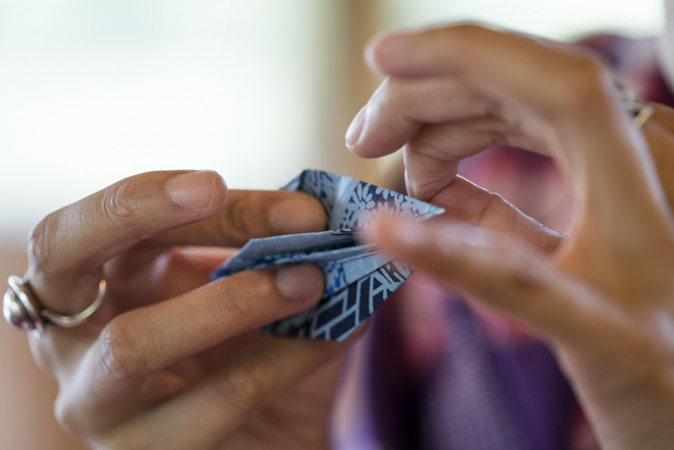 Woman making origami with japanese paper